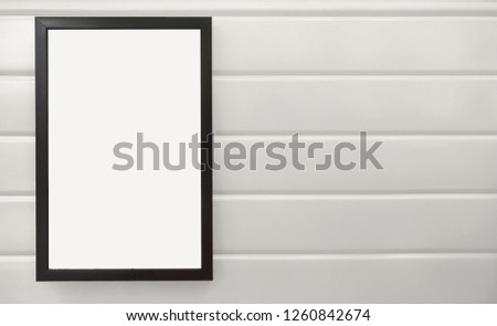 beautiful notification borad hanging on white metal wall, black frame placing on white wall, square black pan on white background