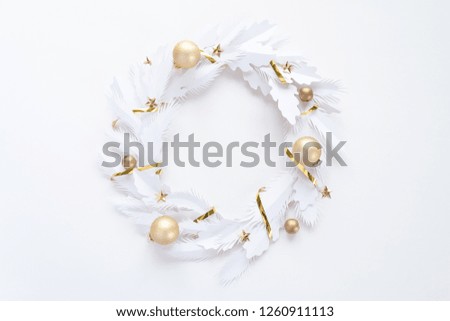 Christmas wreath made of white paper on white background