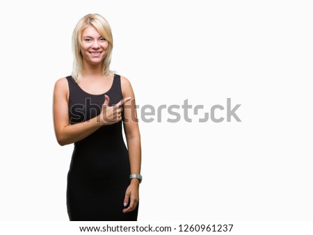 Young beautiful blonde attractive woman wearing elegant dress over isolated background cheerful with a smile of face pointing with hand and finger up to the side with happy and natural expression 