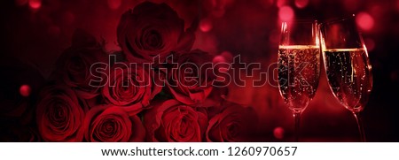 Champagne and red roses with bokeh for valentines day