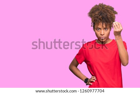Beautiful young african american woman over isolated background Doing Italian gesture with hand and fingers confident expression