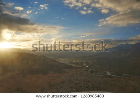 Blur picture of sunrise over the valleys, small town, and desert in Leh, Ladakh, India