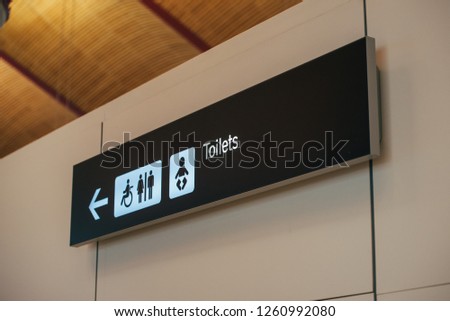 Toilet sign direction at airport