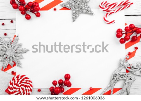 Christmas ornament made of red adornment and text on wooden background