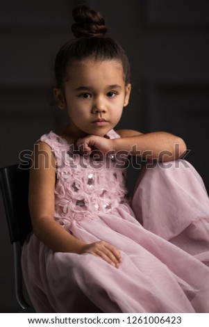 beautiful little Asian model looks in pink dress