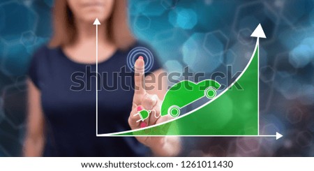 Woman touching an electric car increase concept on a touch screen with her finger