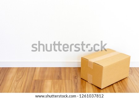 Room of newly built house and cardboard box