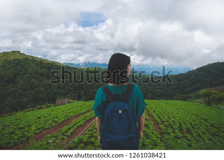happy young cute Asian Japanese girl backpacker woman hipster guiding 
female travelling women backpacking at beautiful sky mountains scenery 
park garden hiking Phu Thap Boek, Phetchabun, Thailand.