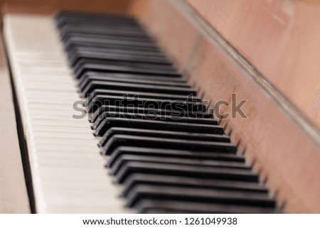 Keys of an old wooden piano. Piano keys on wooden brown musical instrument