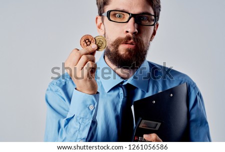 Woman with glasses and coins in the hands of Bitcoin cryptocurrency                