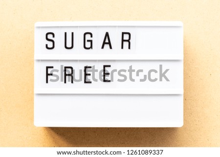 Light box with word sugar free on wood background