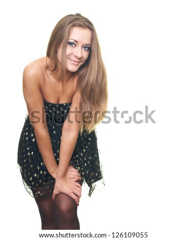Attractive young woman in a black dress leaned forward. Isolated on white background