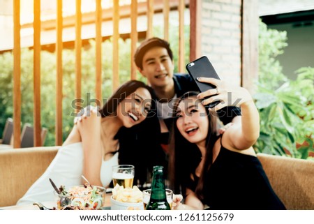 Teenage brides are having fun in the party and using mobile phone talking selfie photo.