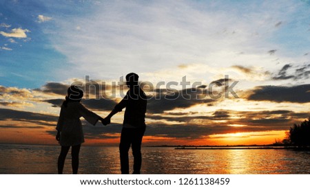 Shadow for man and women hold hand with sunset background.