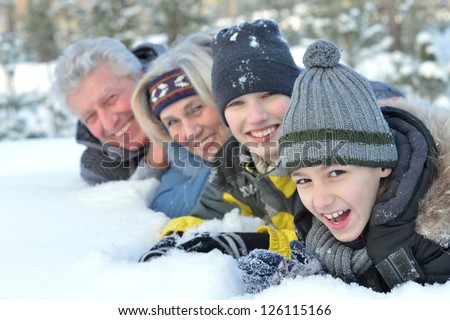 Happy family in warm clothing in winter outdoors