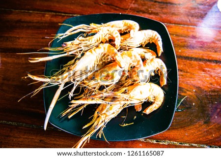 Grilled prawns on black plate, Thailand.