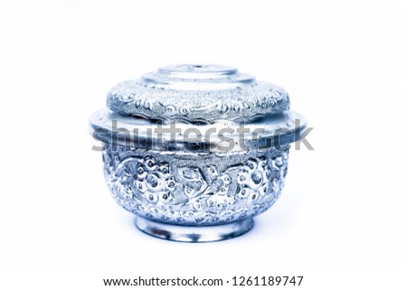 Close up of white or silver colored shiny container isolated on white.