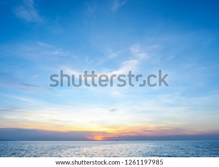 seascape and sun on blue sky background  Royalty-Free Stock Photo #1261197985