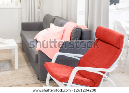 cozy minimalistic interior design in pastel colors in pink and gray. textile pillows, sofa and plaid. living coral