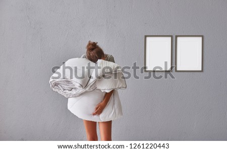 Girl hug pillow and quilt in the room, grey stone wall background frame and picture style.