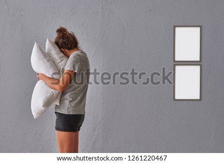 Girl hug pillow and quilt in the room, grey stone wall background frame and picture style.