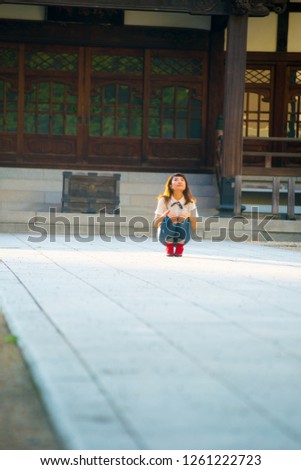 Asian female model poses for pictures on the street