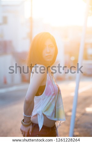 Asian female model poses for pictures on the street