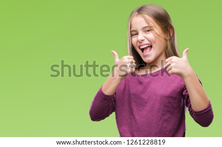 Young beautiful girl over isolated background success sign doing positive gesture with hand, thumbs up smiling and happy. Looking at the camera with cheerful expression, winner gesture.