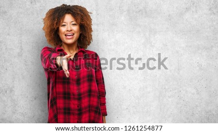 Young black afro woman reaching out to greet someone