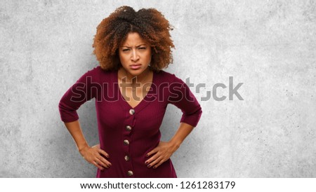 Young black afro woman scolding someone very angry