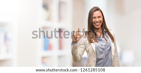 Caucasian business young woman doing a rock gesture