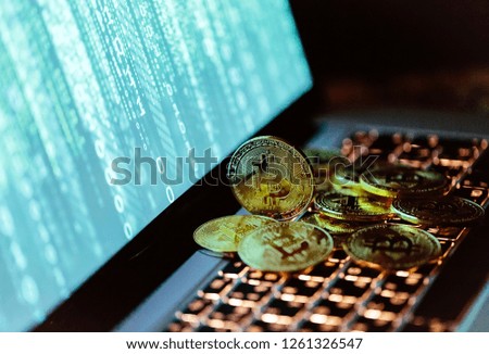 Bitcoin coins on laptop keyboard. Cryptocurrency