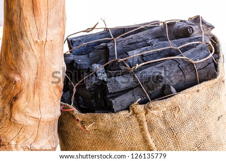 Black Firewood in bag with white background