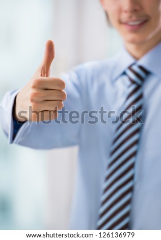 Business man hand closeup with thumb up