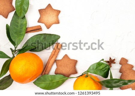 Border of Christmas star cookies with spices and mandarin on white background with copyspace. Top view