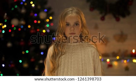 Portrait of beautiful little girl at Christmas eve, faith in miracle, childhood