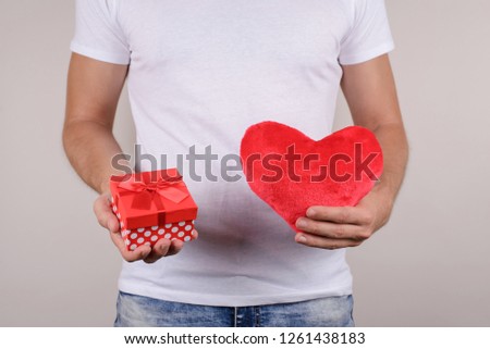 Cropped close up view studio portrait photo of handsome strong masculine happy positive smiling virile guy giving you his heart and mini box isolated grey background