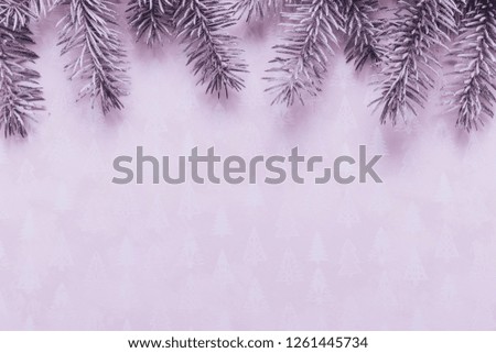 Christmas composition. Border made of fir tree branches, christmas decorations on pink background. Christmas, winter, new year concept. Flat lay, top view, copy space.
