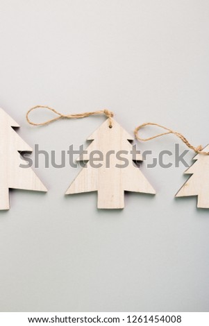 Christmas and New Year's Day festive decoration, wooden Christmas trees on gray background.  Copy space for text. Flat lay. View from above.