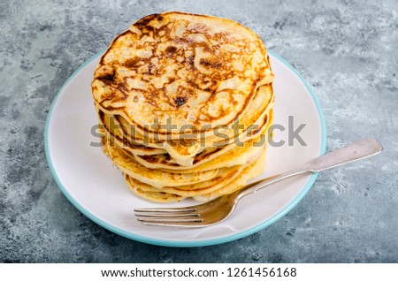 White plate with pancakes on wooden table. Studio Photo