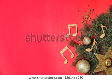 Flat lay composition with fir tree, Christmas decor and wooden music notes on color background. Space for text