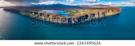 Aerial view of the dramatic coastline at the cliffs by Staffin with the famous Kilt Rock waterfall - Isle of Skye - Scotland. Royalty-Free Stock Photo #1261490626