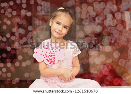 Pretty little girl in soft pink dress thinking about love and looking coquettish, she falls in love, romantic and love concept, Valentine Day greeting