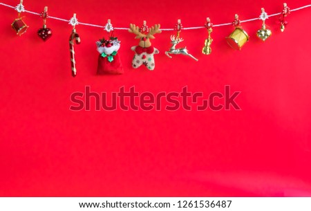 Christmas  decoration  hanging  on  the  rope  with  red  background