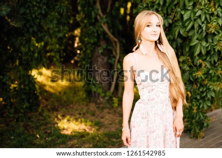 beautiful young girl in a white dress with long hair resting outdoors, amazing woman walking in the park