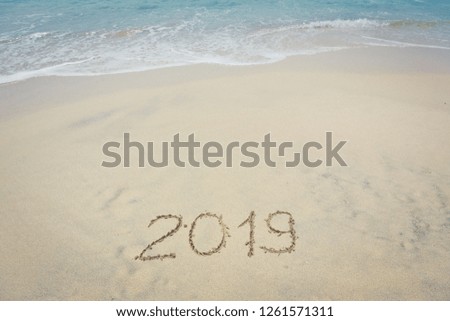 Word 2019 writing in sand, on tropical beach