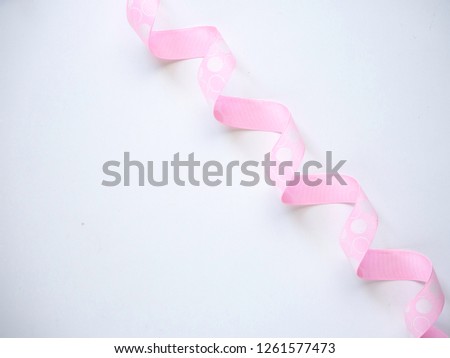 Pink curly ribbon on a  white background. flat lay photo copy space
