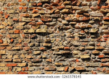 Italy Ravenna, medieval stone and brick wall.