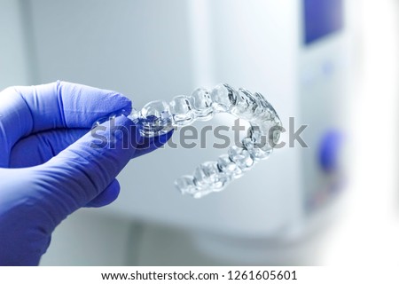 dental orthodontic mouthguards in blue glove on a light background Royalty-Free Stock Photo #1261605601