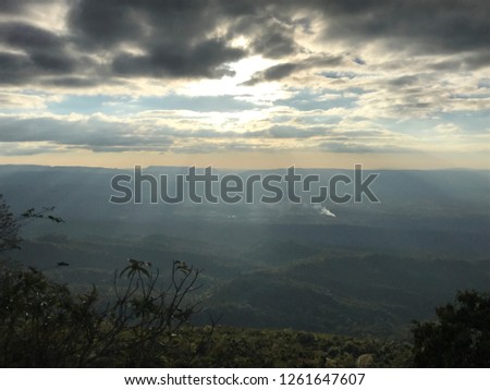 Scenic view of the green mountain against the light rays shine through the clouds